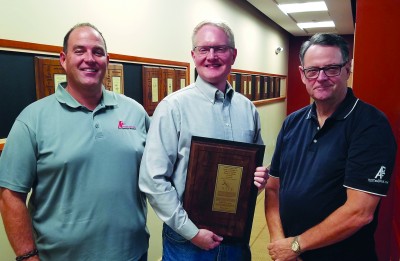 Jim McHugh (left), Ben Gleeson (middle), and George McHugh IV (Right) pose with the patent for the PURGEnVENT automatic air vent assembly.